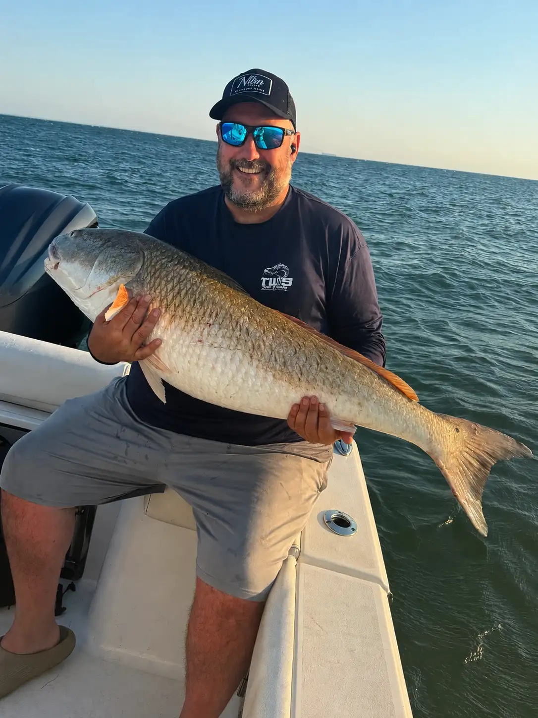 Brian Mayer holding a red drum while fishing on the Chesapeake Bay