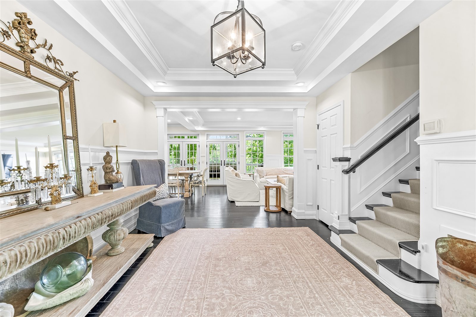 Henson home foyer with staircase and view into the living room